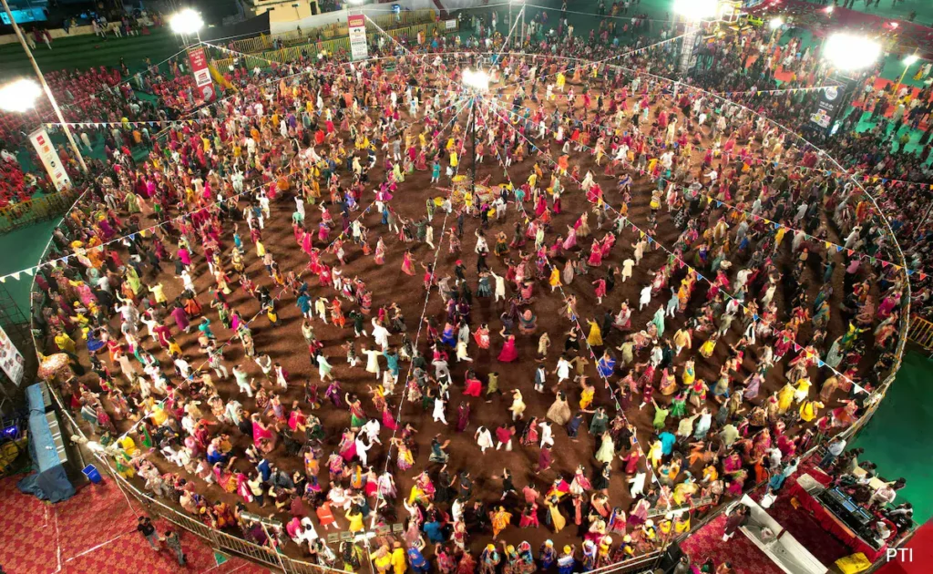lots of people doing garba, devotional display 